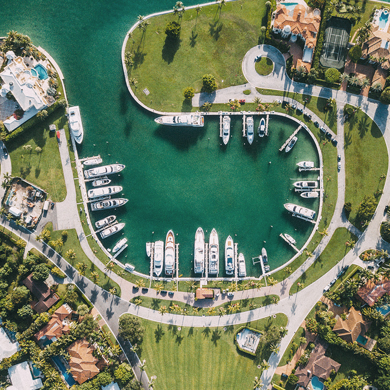 Top aerial view of a private boat marina and luxury homes.